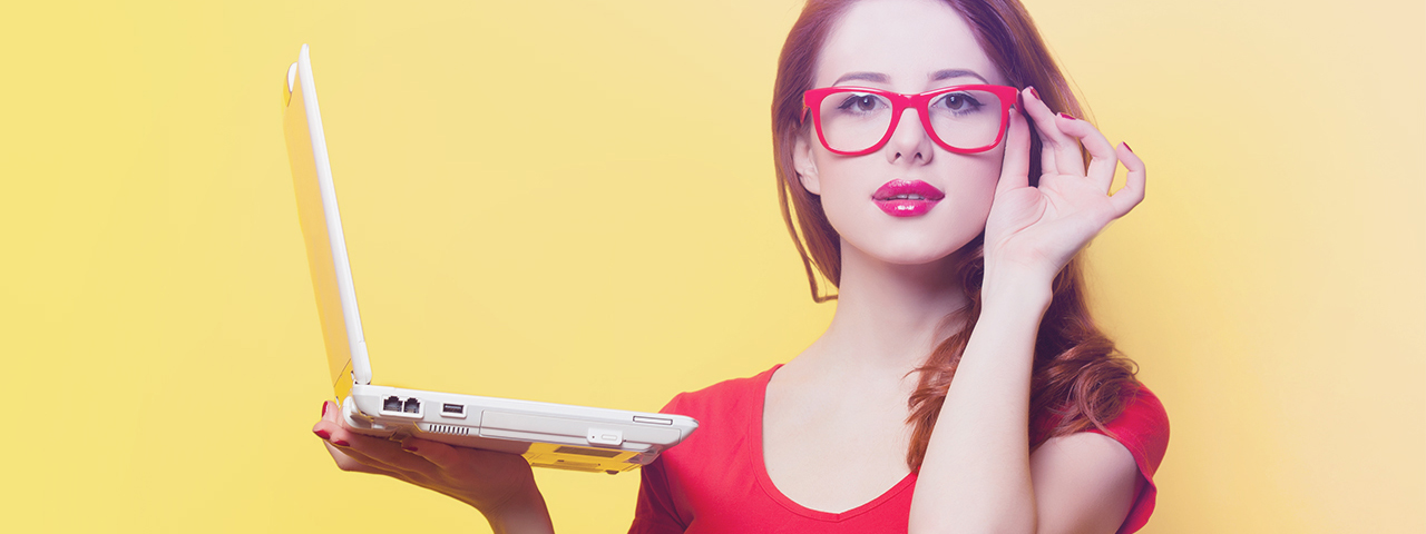 a-woman-holding-a-laptop-red-glasses